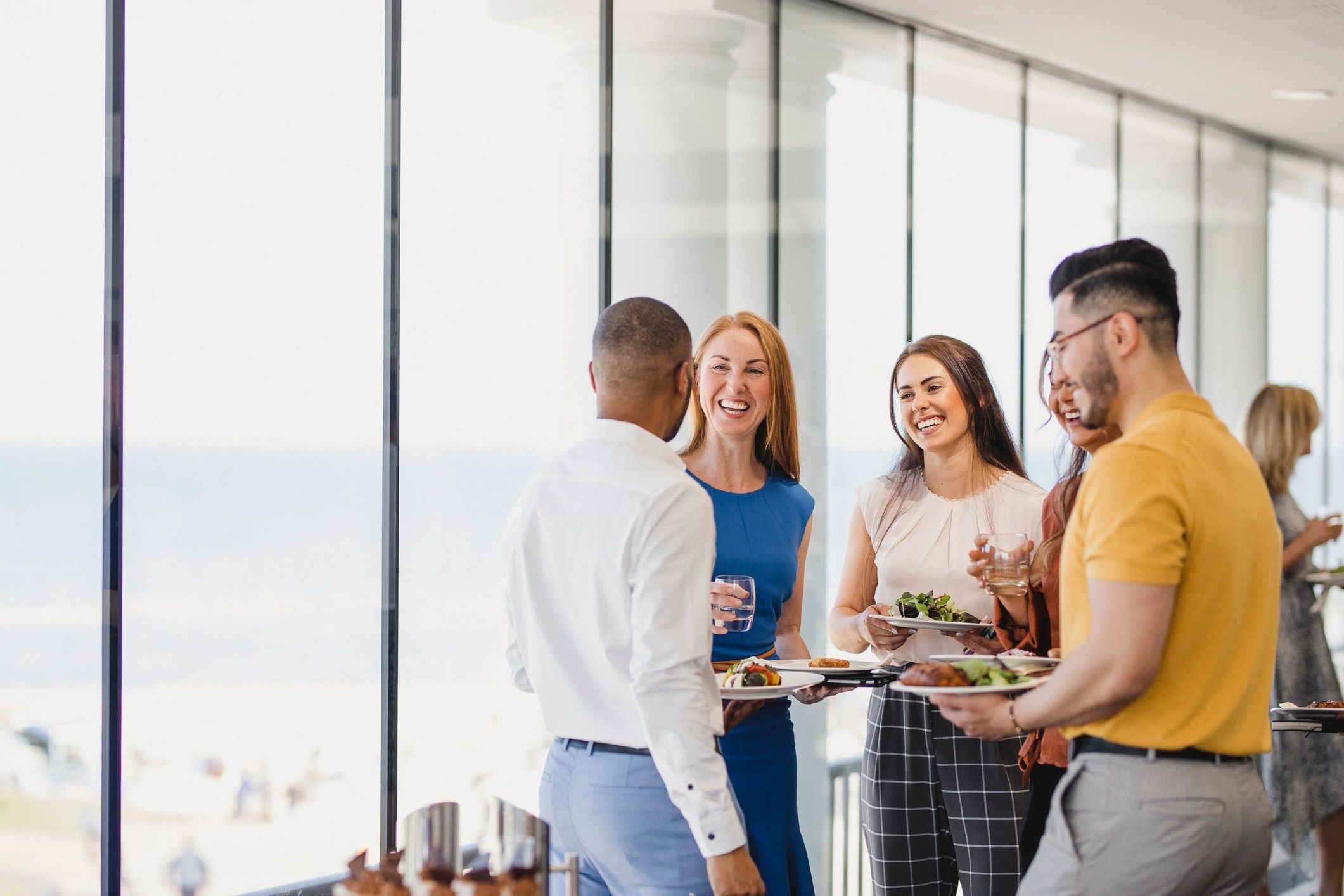 Guests enjoying catered food at a corporate event