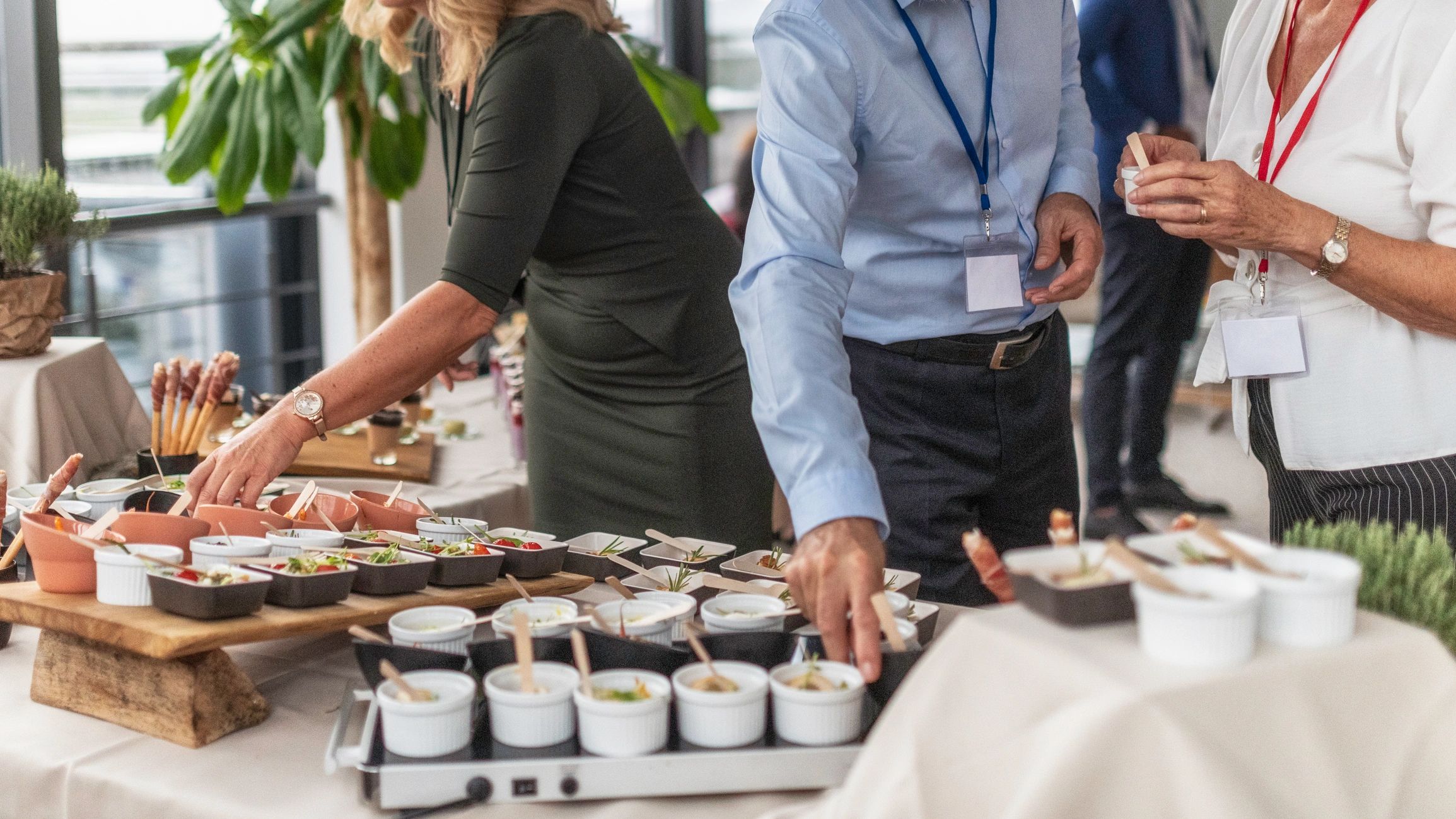 Guests reaching for food at a catered corporate event